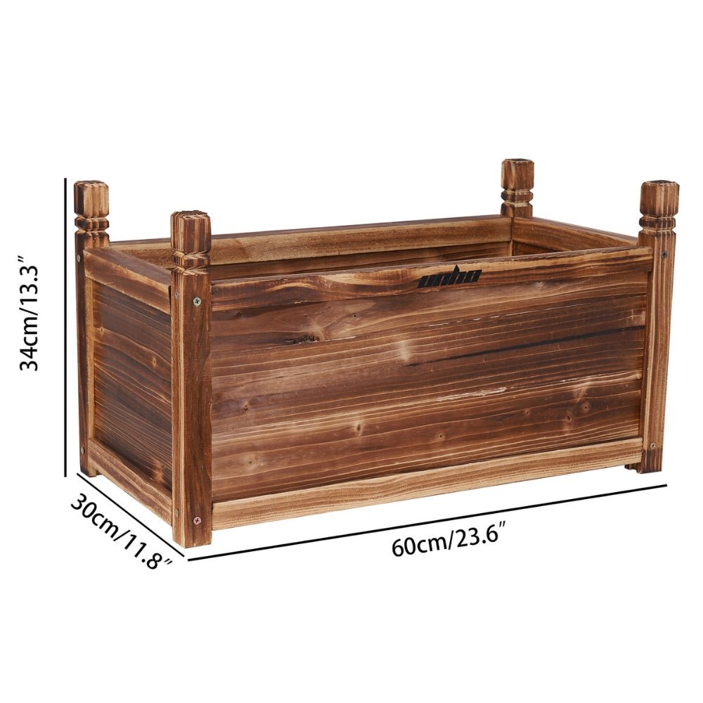 Decorative wooden planter box planted with flowering annuals in a cottage garden